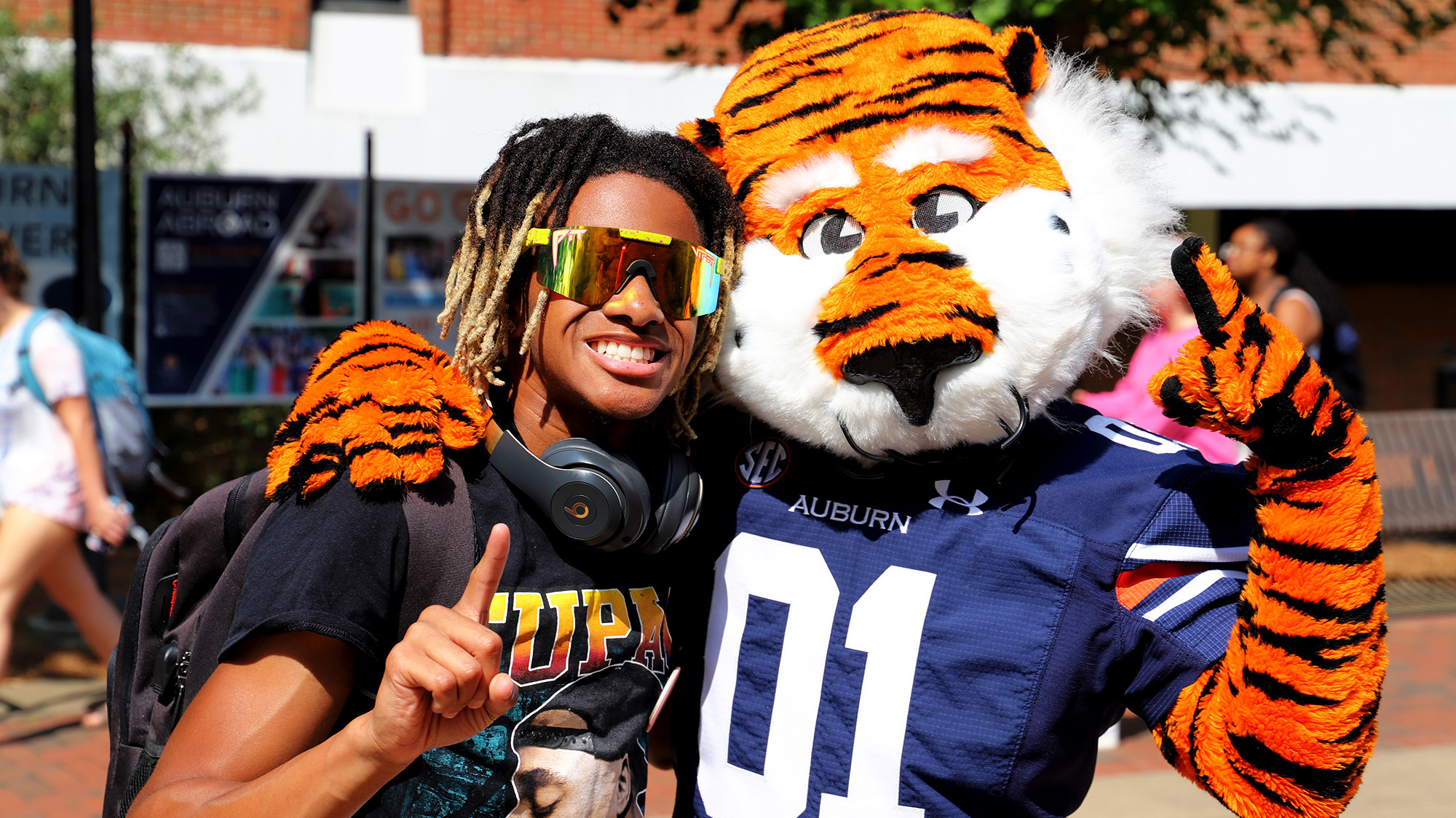 Student poses for a photo with Aubie