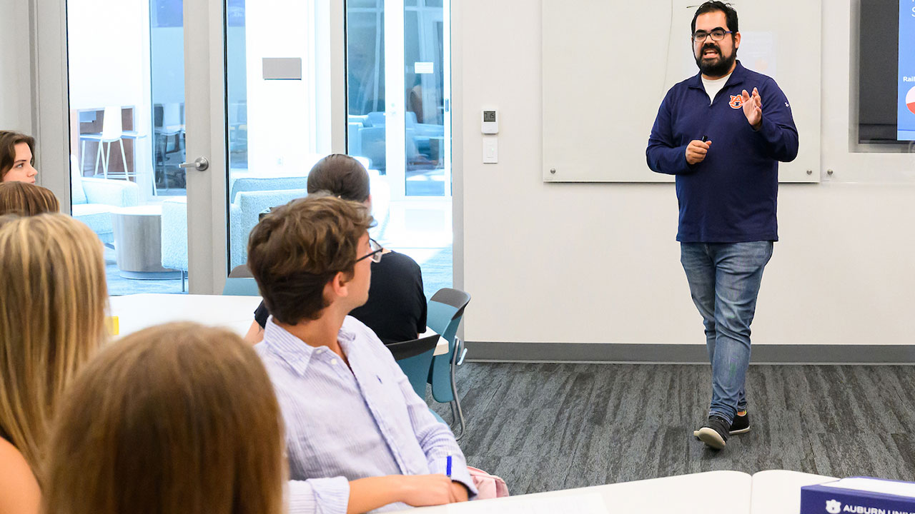 A faculty member teaches in a classroom in the college of education building.