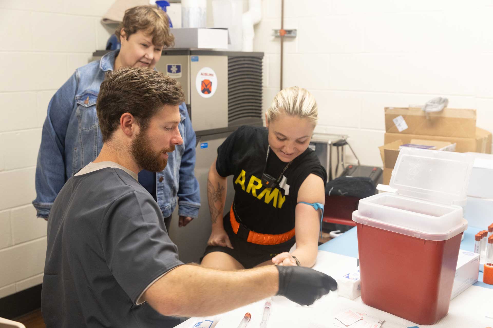 Dr. Sefton and a student working with a patient in the Warrior Research Center.