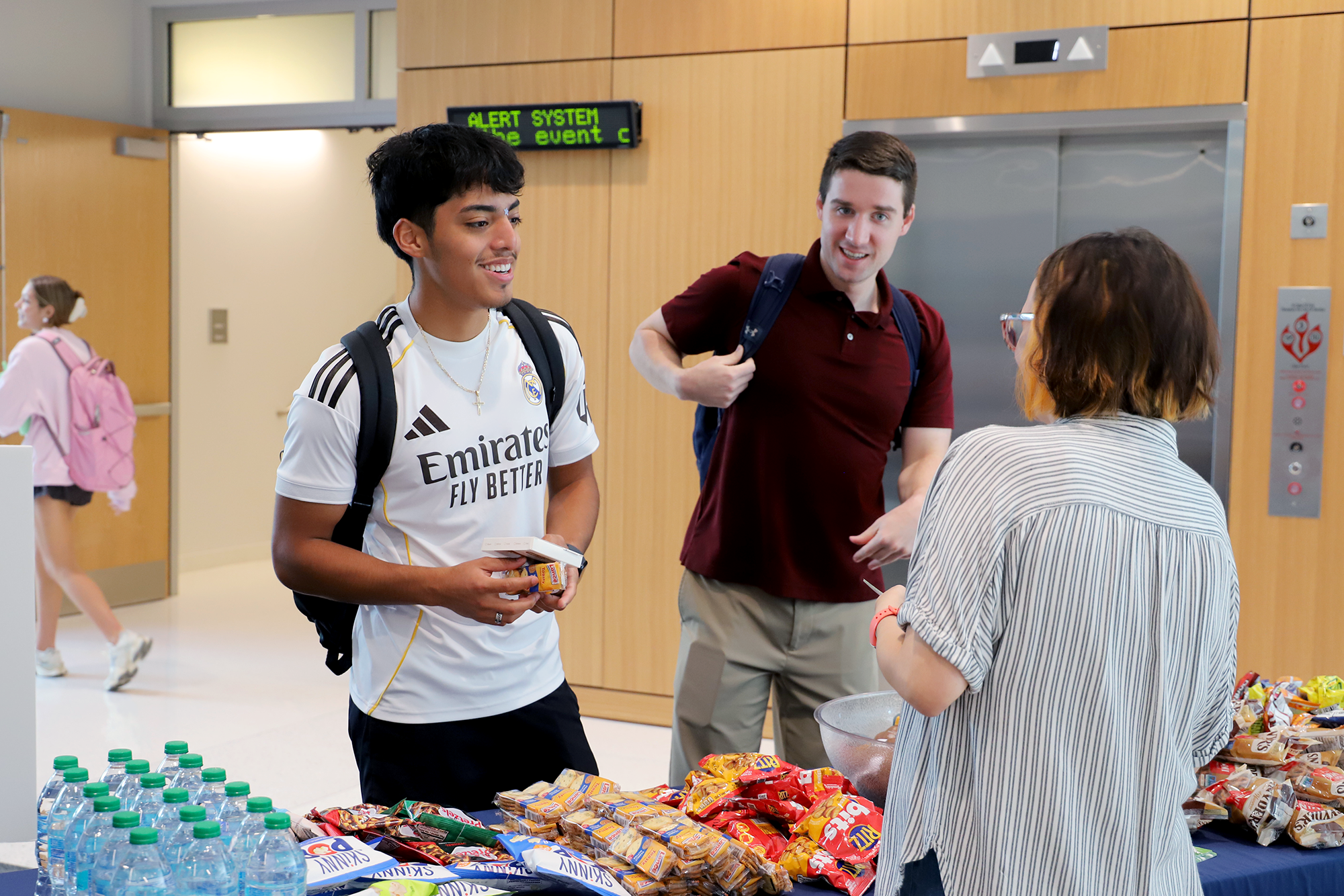 Students pick up snacks in the college of education building during welcome week.