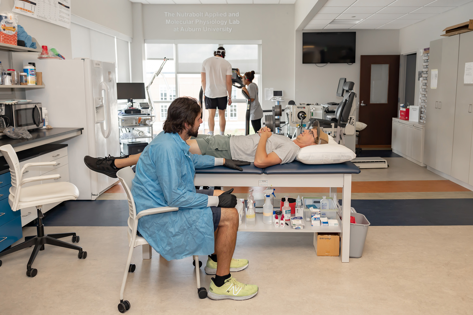 A student works with a patient on a table