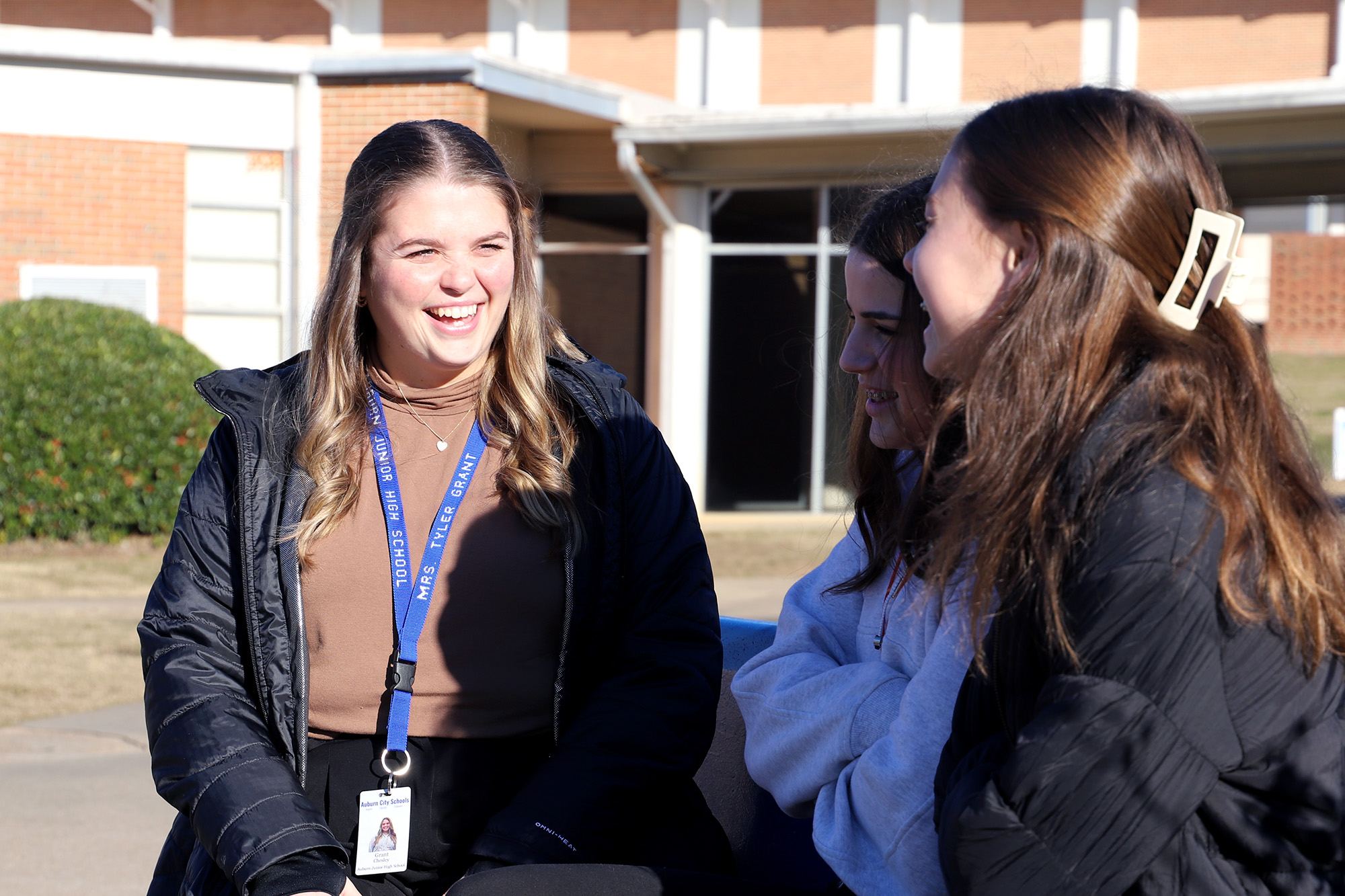 A counselor talks with two students