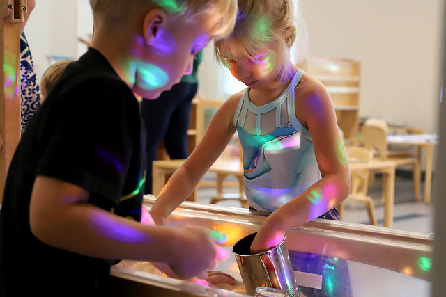 Children play with a light box