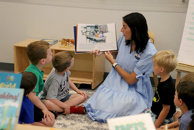 A student teacher reads to children