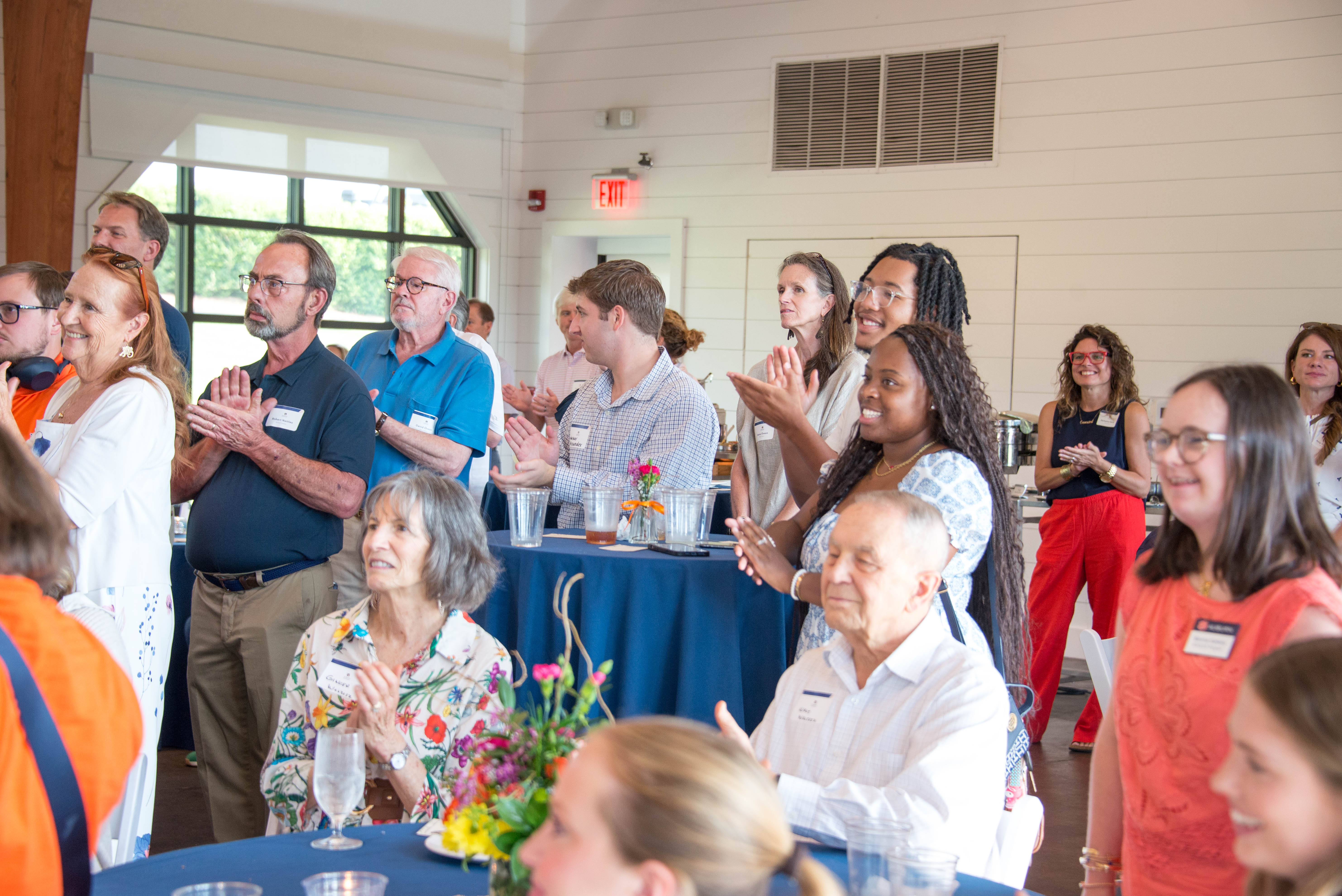 A candid shot of the crowd including council members at the red barn.