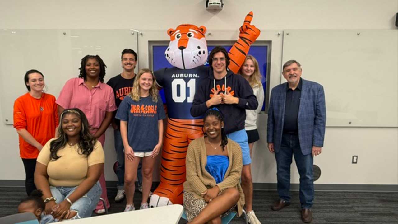 Math education students pose with inflatable Aubie and Gary Martin
