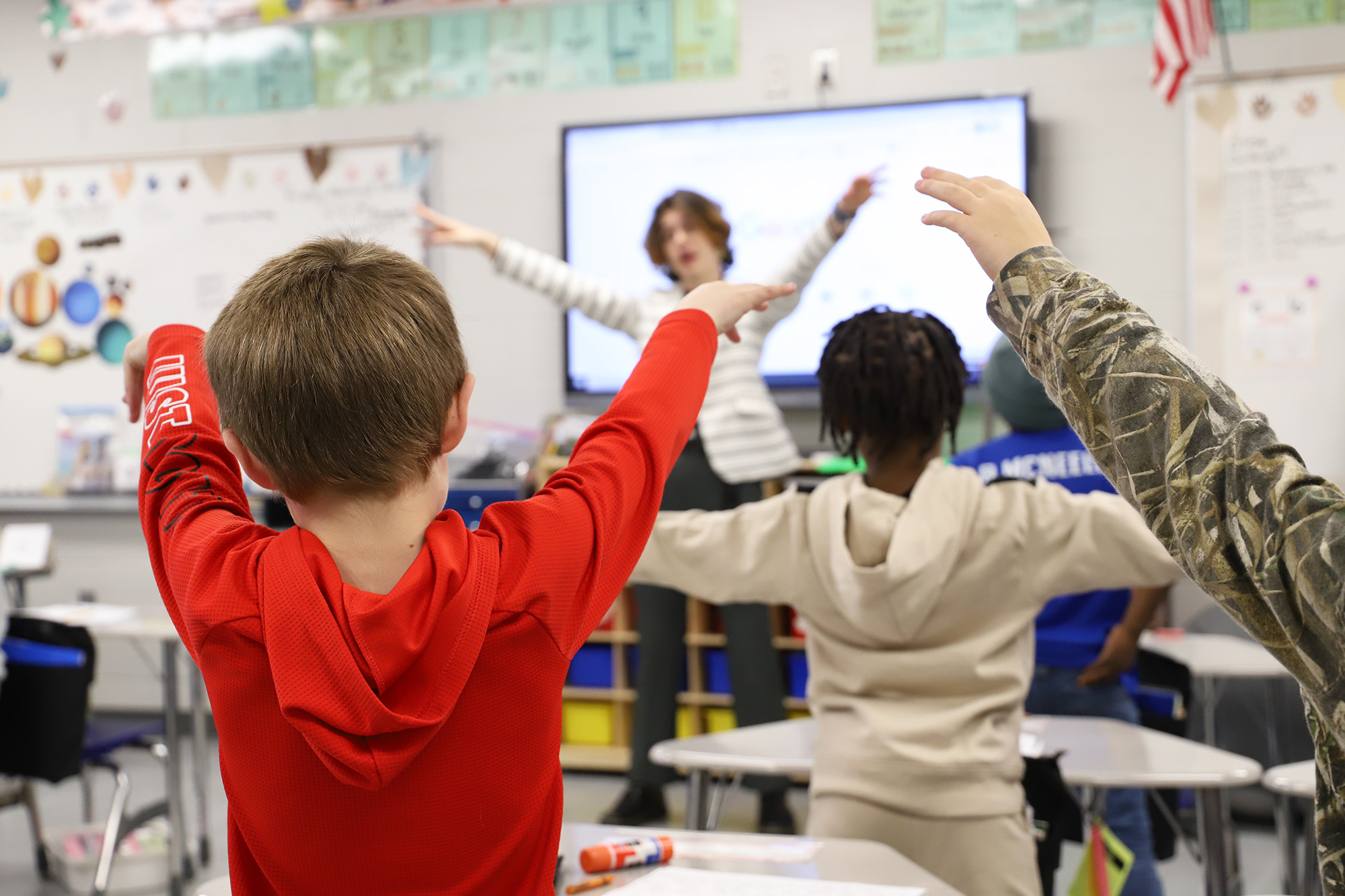 A student teacher works teaches music to students