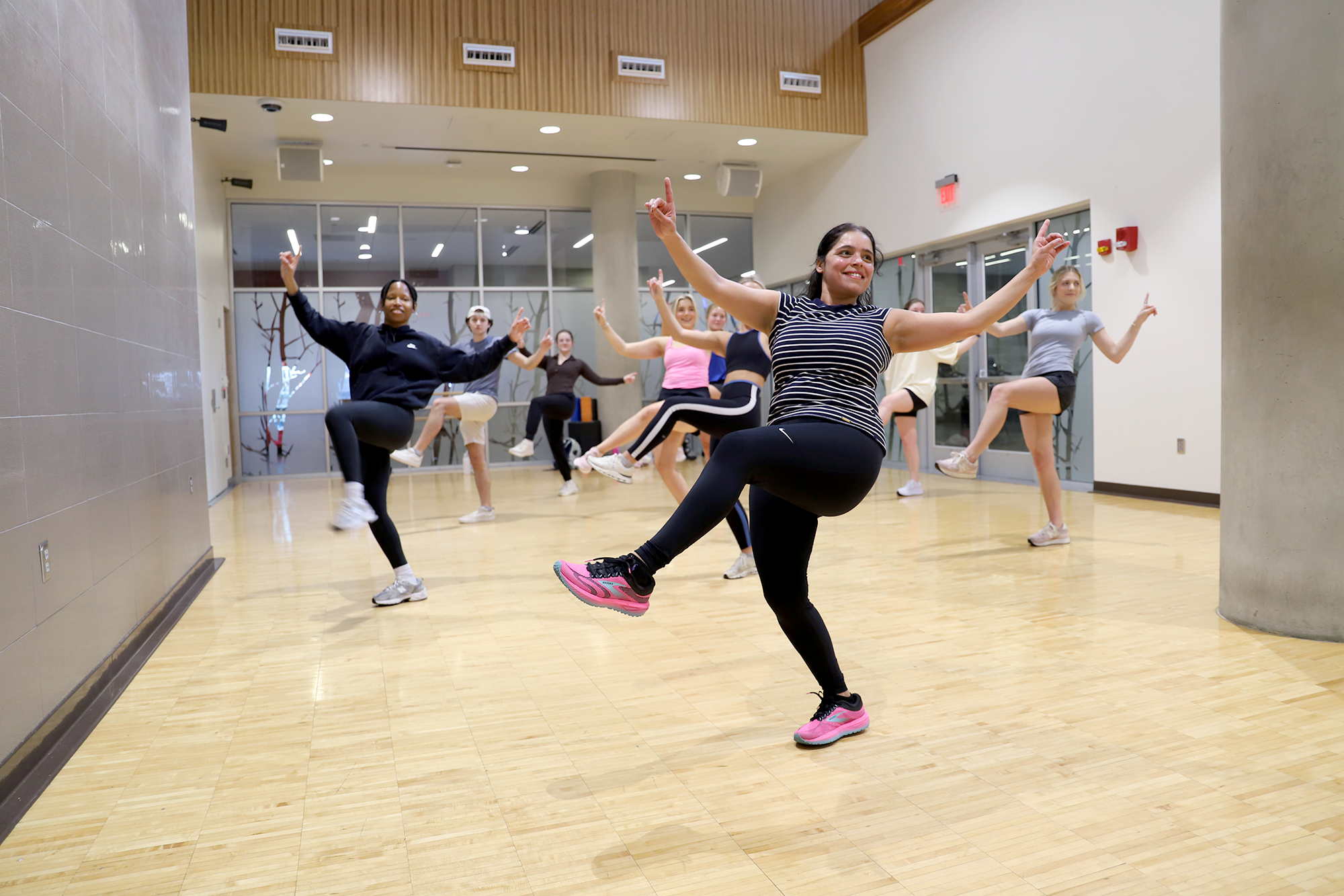 Students participate in a group fitness dance class