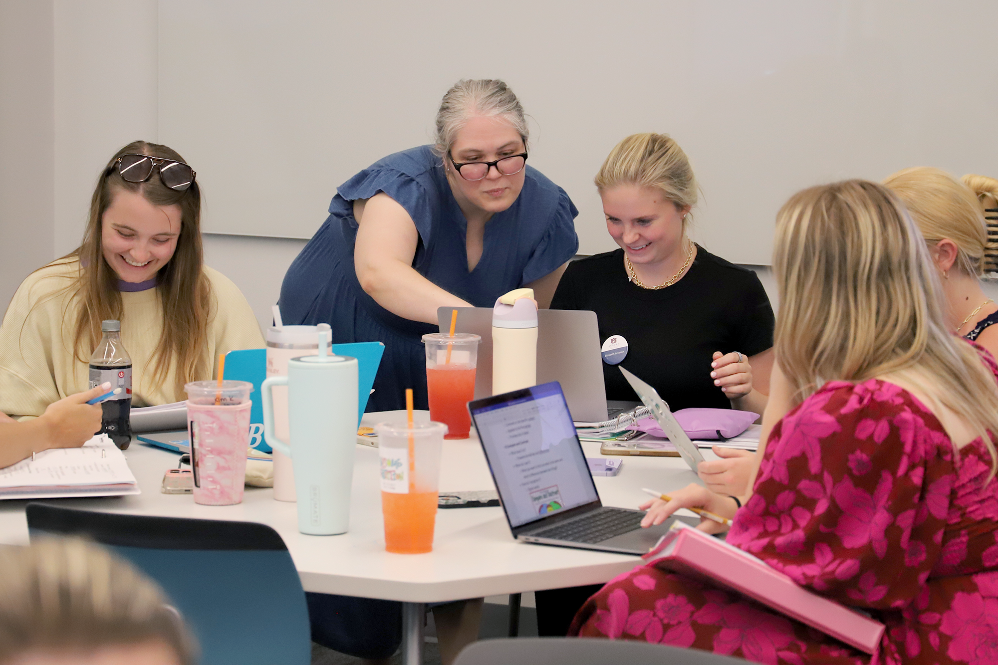 A teacher working with students in a classroom
