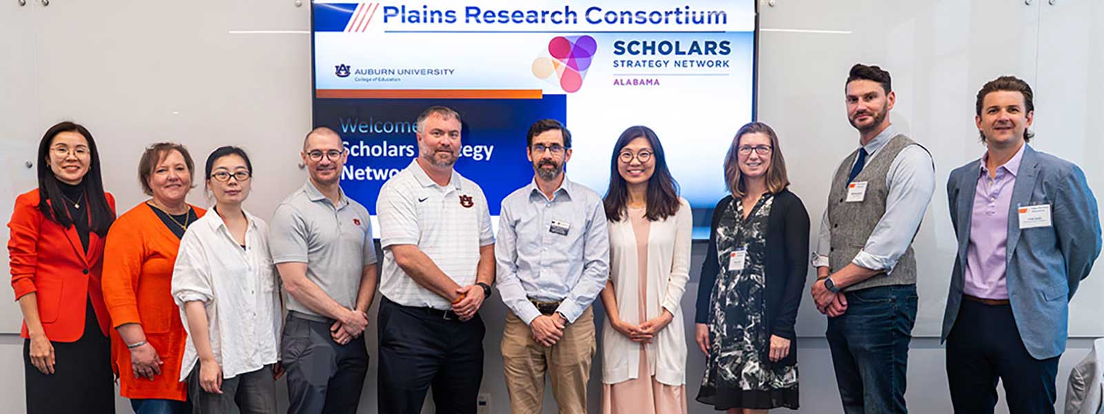 Members of Auburn's Plains Research Consortium and the Scholars Strategy Network pose for a photo inside the College of Education Building.