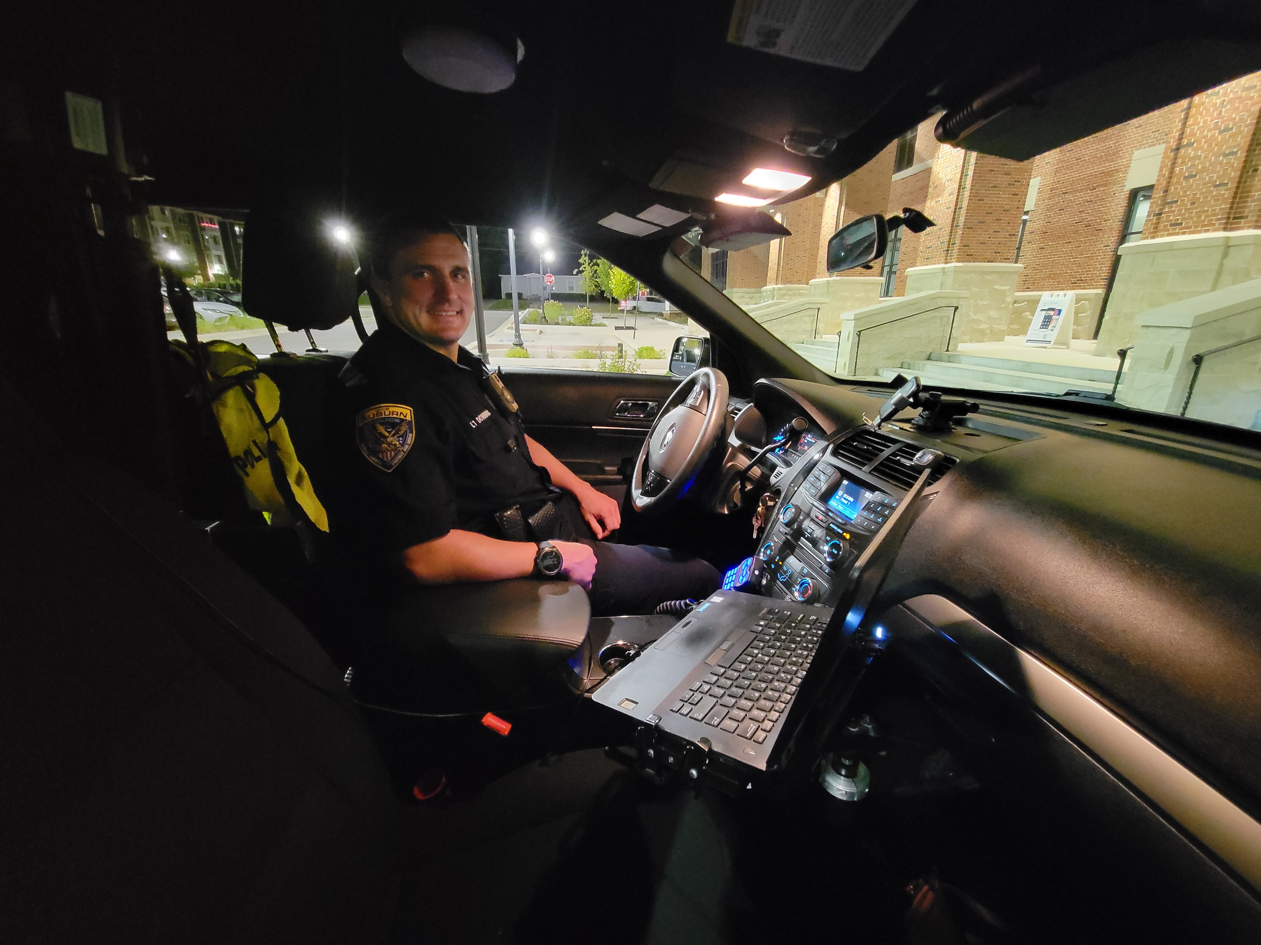 An Auburn Police Officer in his patrol vehicle.