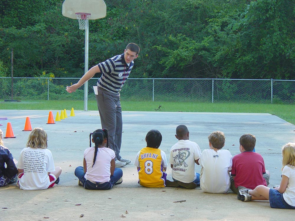 An instructor talks to kids