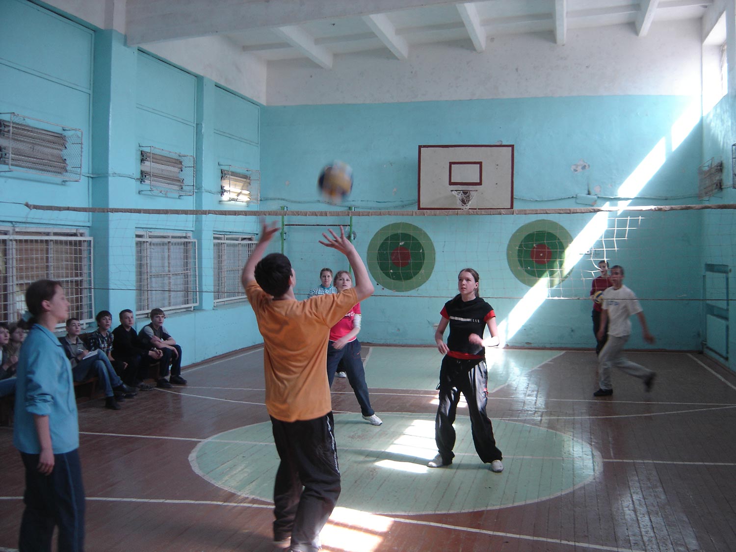 Kids playing volleyball in side