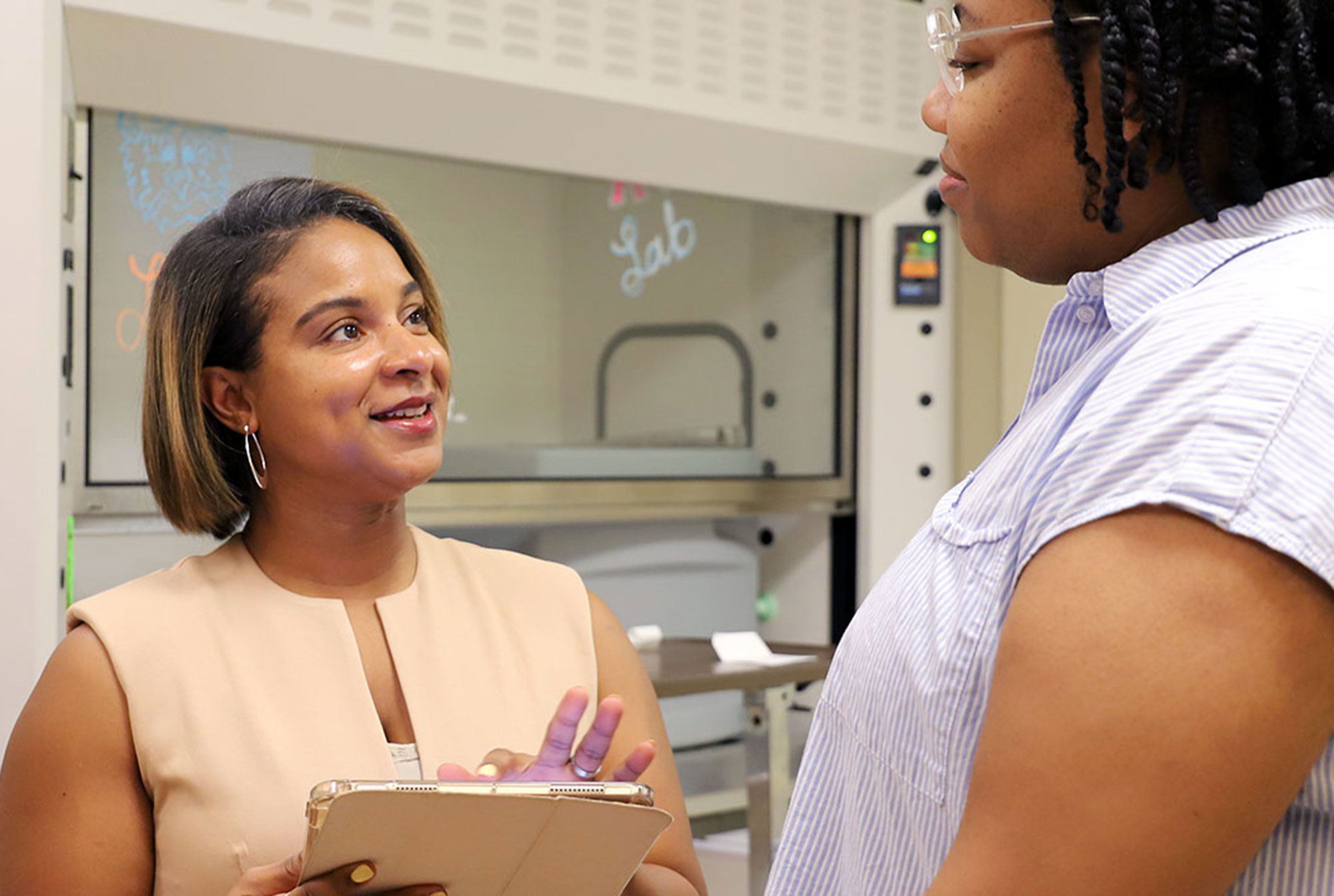 A faculty member speaks with a student