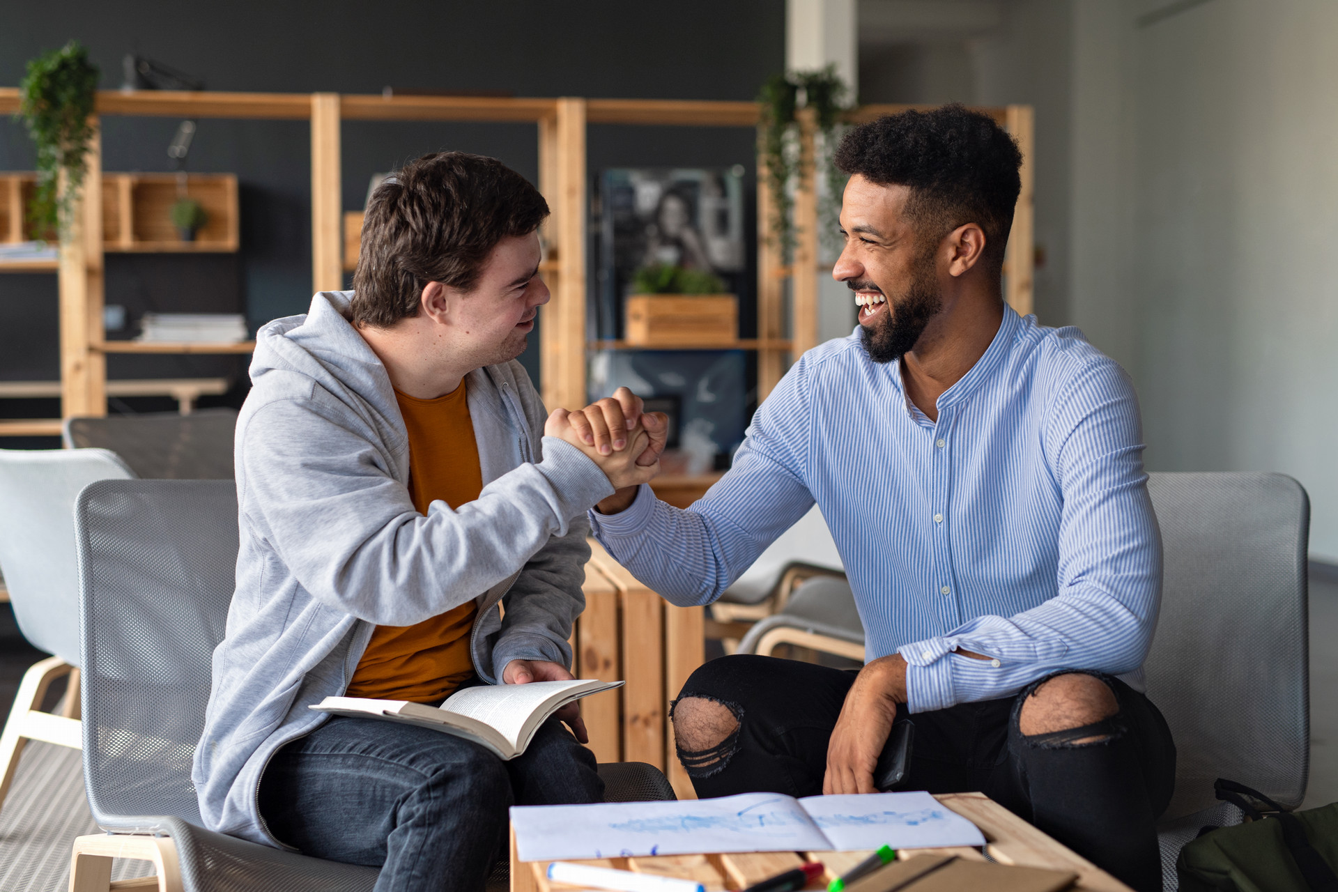 Stock photo of a teacher high-fiving a student.