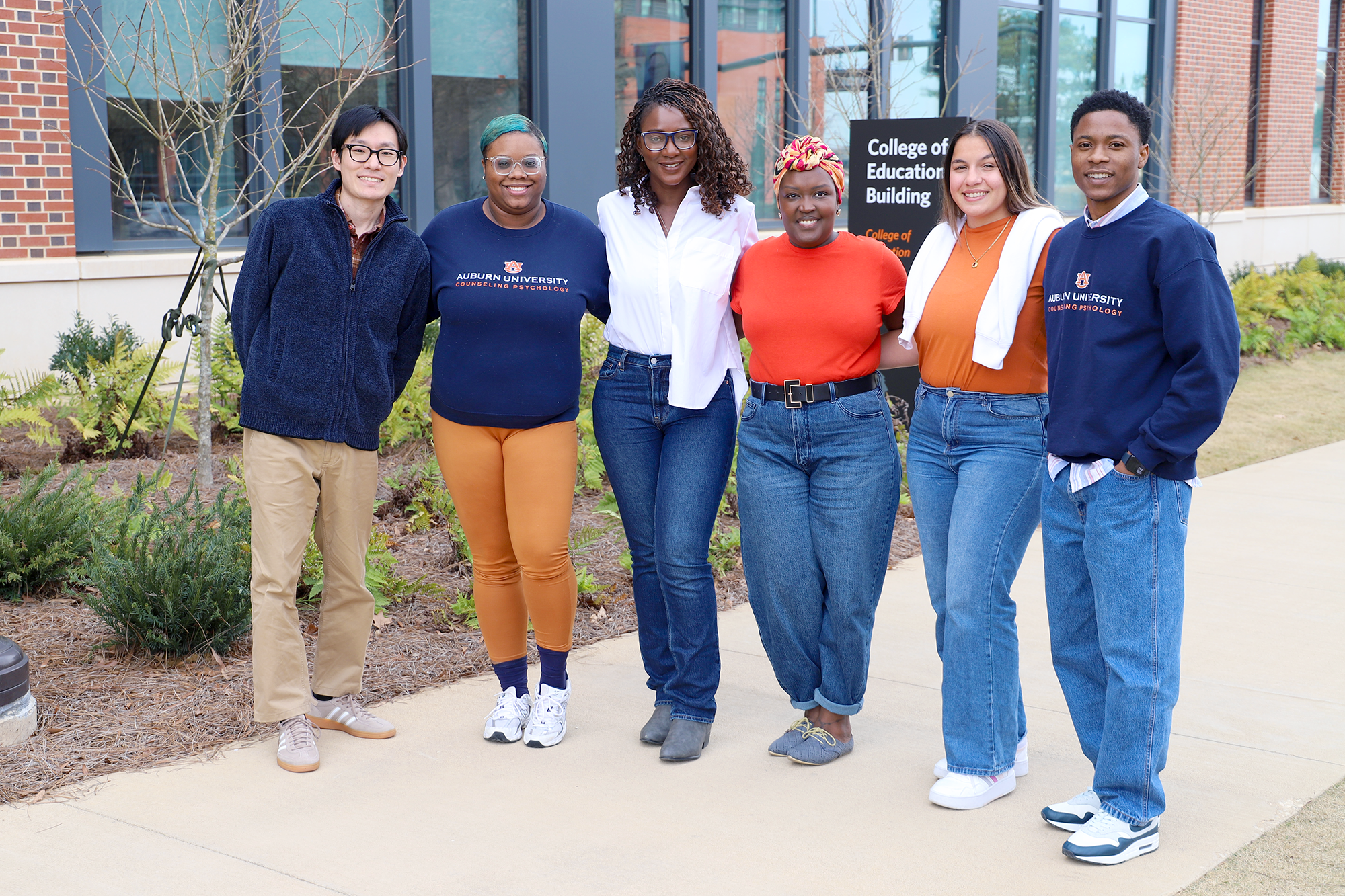 lab members pose outside the college of education building.